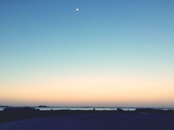 Scenic view of sea against clear sky during sunset