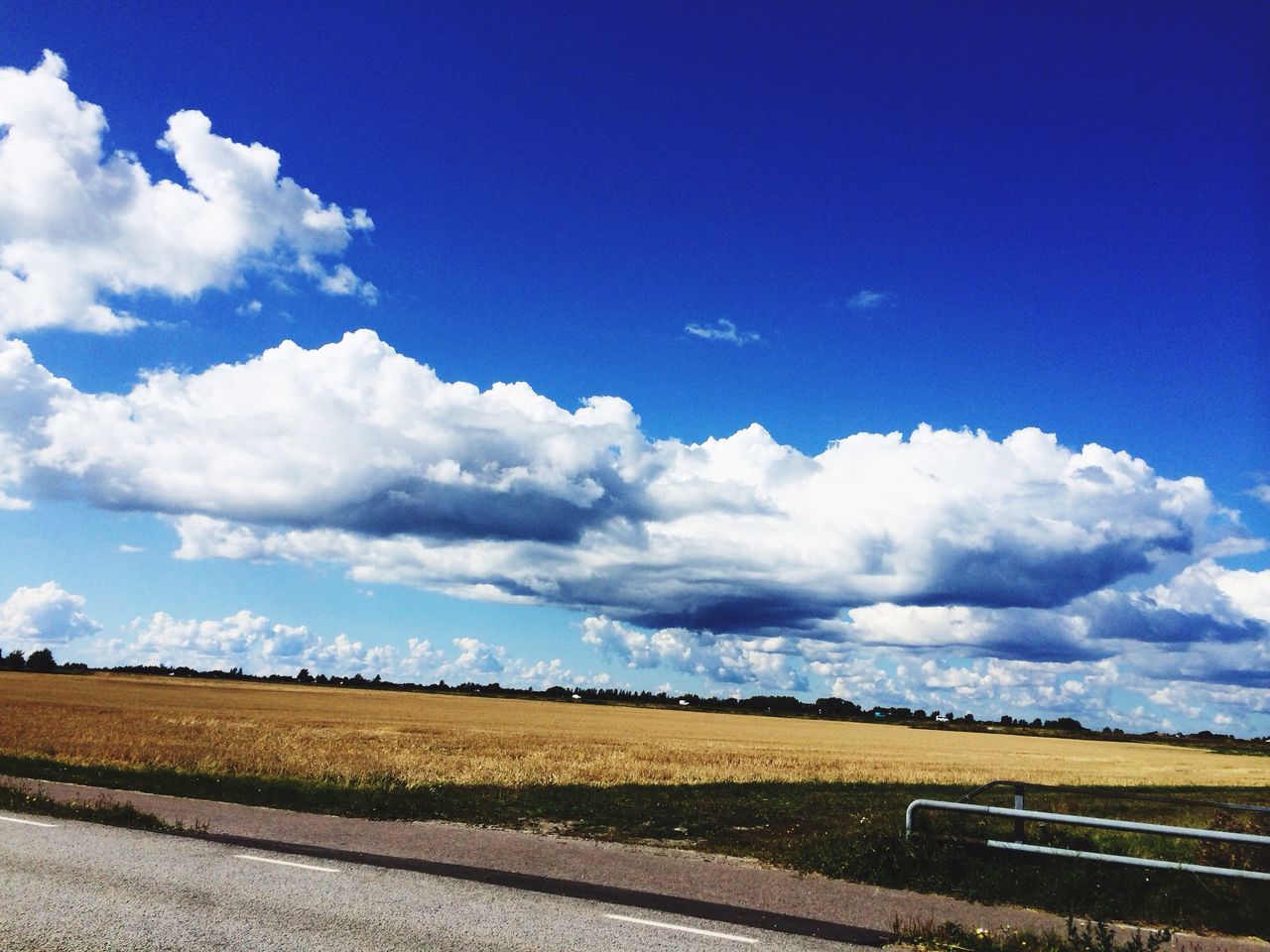 sky, landscape, blue, field, tranquil scene, tranquility, cloud - sky, cloud, scenics, beauty in nature, rural scene, nature, horizon over land, agriculture, transportation, road, day, farm, outdoors, no people