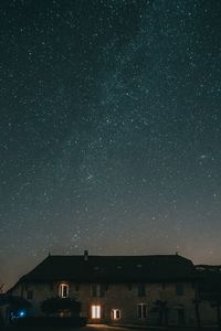 Low angle view of illuminated building against sky at night