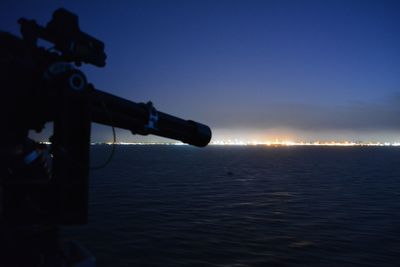 View of illuminated sea at night