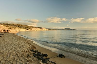 Scenic view of beach against sky during sunset