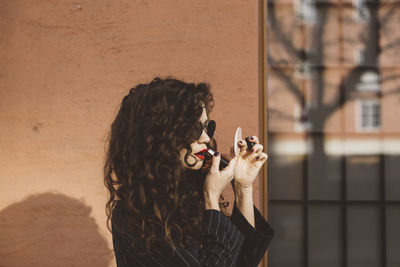 Woman applying lipstick