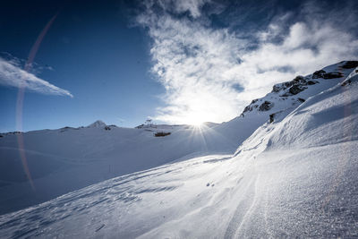 Scenic view of snowcapped mountains against sky