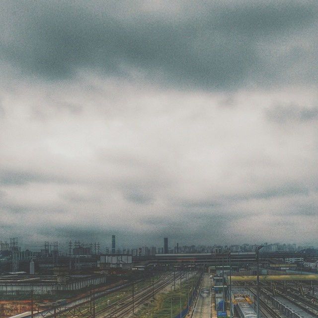 sky, cloud - sky, railroad track, cloudy, transportation, rail transportation, weather, overcast, landscape, the way forward, cloud, road, nature, diminishing perspective, field, day, built structure, no people, outdoors, vanishing point