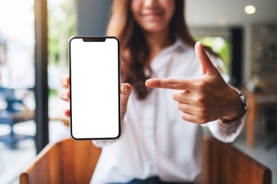 Midsection of woman using mobile phone