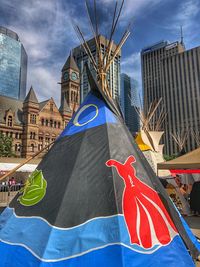 Low angle view of flag against buildings in city