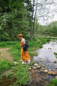 Side view of man walking in forest