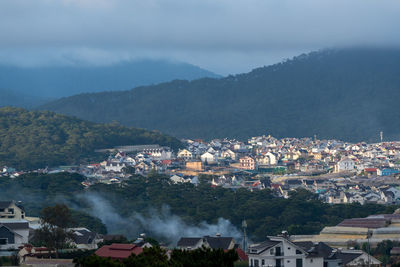 High angle view of townscape and mountains against sky