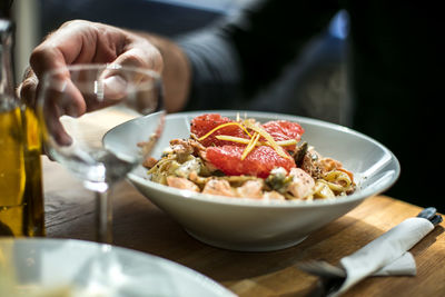 Close-up of man with pasta in bowl