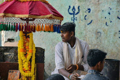 Young man wearing traditional clothing looking away