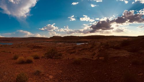 Scenic view of arid landscape against sky