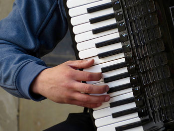 Close-up of man playing piano