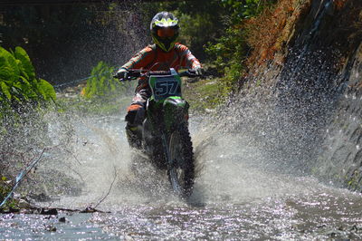 Man riding motorcycle on water