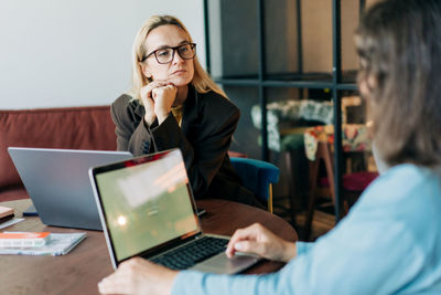 Young woman using laptop at table