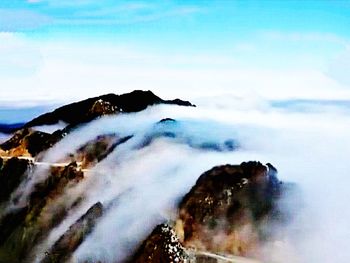 Scenic view of rocks in sea against sky