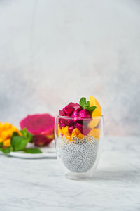 Close-up of multi colored fruits in glass on table