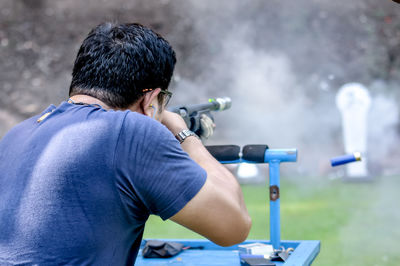 Rear view of man photographing