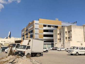 Cars on street against clear sky