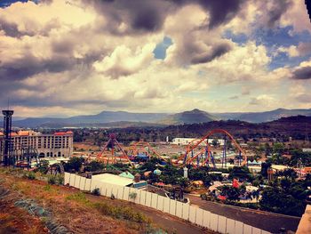 Cityscape against cloudy sky