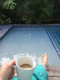 Close-up of hand holding coffee cup