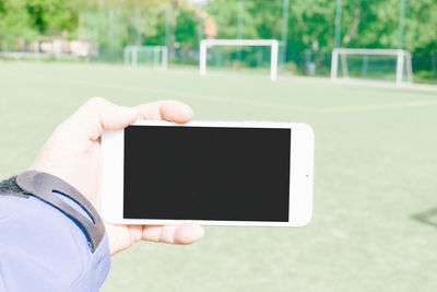 Midsection of man using mobile phone