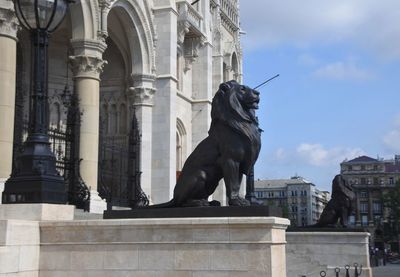 Lion statue in front of hungarian parliament building