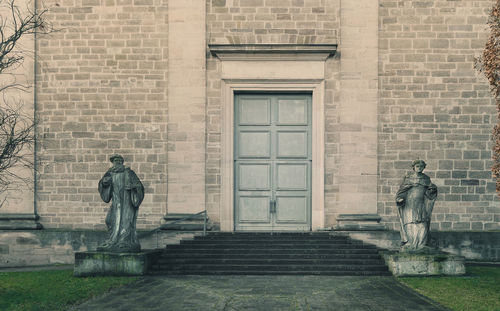 Two figures beside the church entrance
