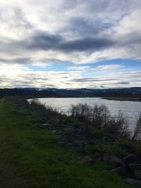 Scenic view of lake against cloudy sky