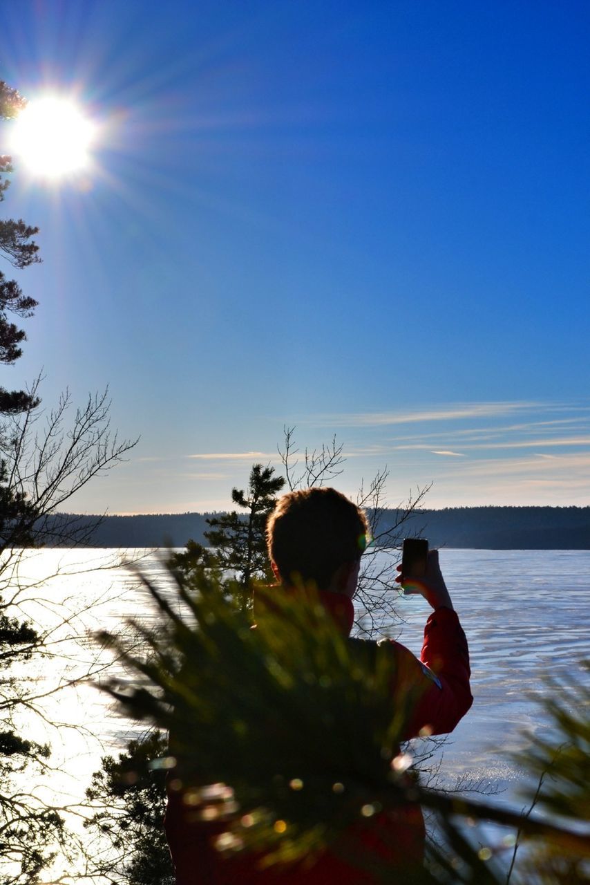 SILHOUETTE OF MAN IN SEA