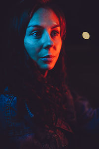 Portrait of a woman in neon light at night