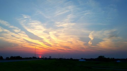 Scenic view of landscape against sky at sunset