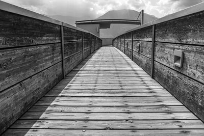 Footbridge over footpath against sky