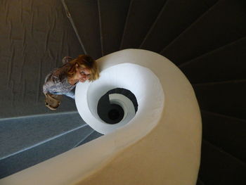 High angle portrait of woman standing on staircase