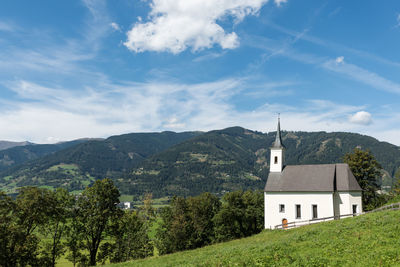 Church and mountains against sky