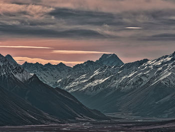 Scenic view of snowcapped mountains against sky during sunset