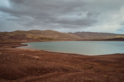 Scenic view of lake and mountains against sky