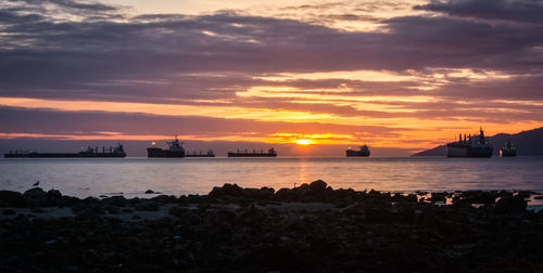 Silhouette of ships at sunset