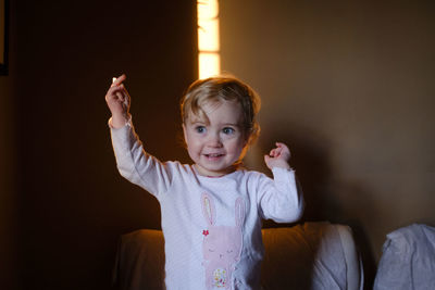 Close-up of cute baby girl at home