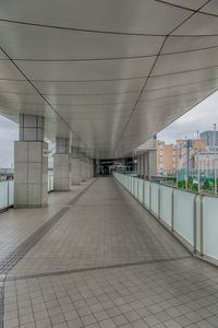 Empty footpath in illuminated building