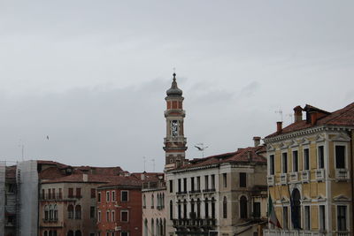 Buildings in town against sky