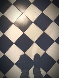 Low section of person walking on tiled floor