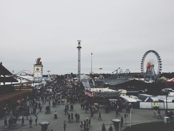 High angle view of people in amusement park against sky