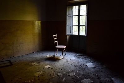 Empty chair in abandoned home
