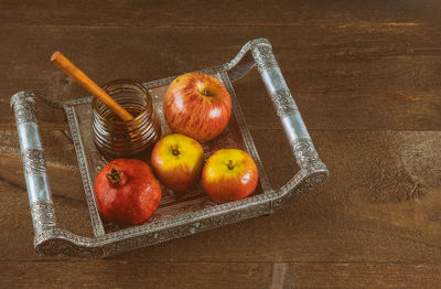 High angle view of fruits in basket on table