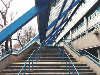 Low angle view of staircase amidst buildings in city