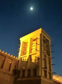 Low angle view of illuminated building against clear sky