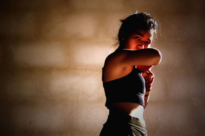 Side view of young woman standing outdoors