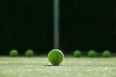 Close-up of tennis balls on field in court