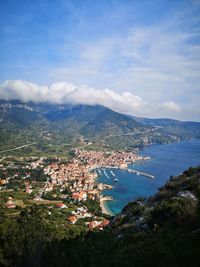 High angle view of townscape and sea against sky