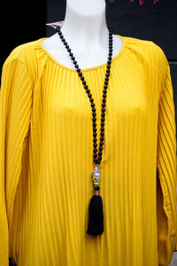 Close-up of yellow clothing in mannequin